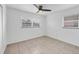 Bright bedroom with tile flooring, white walls, and a ceiling fan at 4608 Park Acres Dr, Bradenton, FL 34207