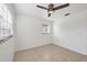 Bright bedroom featuring tile floors, white walls, and a ceiling fan at 4608 Park Acres Dr, Bradenton, FL 34207