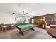 The game room is equipped with a pool table, vintage lighting fixtures, and classic wood paneling at 4608 Park Acres Dr, Bradenton, FL 34207