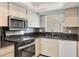Contemporary kitchen with sleek appliances, granite countertops, and stylish backsplash at 4608 Park Acres Dr, Bradenton, FL 34207