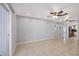 Open living room with tile flooring, ceiling fan, mirrored wall, and seamless flow to the kitchen at 4608 Park Acres Dr, Bradenton, FL 34207