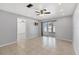 Spacious living room with tile flooring, ceiling fan, and sliding glass doors to the lanai at 4608 Park Acres Dr, Bradenton, FL 34207