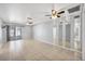 Large living room with tile floors, multiple ceiling fans, mirrored wall, and access to the screened porch at 4608 Park Acres Dr, Bradenton, FL 34207