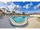 Community pool with lounge chairs and well-maintained landscaping, perfect for relaxation at 4608 Park Acres Dr, Bradenton, FL 34207