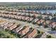 Aerial view of a residential neighborhood with a lake, golf course, and well-maintained homes with tile roofs and green lawns at 5020 Savona Run, Bradenton, FL 34211