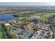 Aerial view of the community featuring tennis courts, a pool, and a golf course at 5020 Savona Run, Bradenton, FL 34211