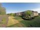 Spacious backyard featuring a lush green lawn, screened in lanai and lush plants and trees at 5020 Savona Run, Bradenton, FL 34211