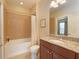 Bright bathroom featuring a bathtub with tile surround, granite countertop and modern fixtures at 5020 Savona Run, Bradenton, FL 34211