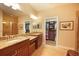 Bright bathroom featuring double vanities with granite countertops and a walk-in closet at 5020 Savona Run, Bradenton, FL 34211