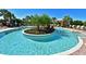 The community pool features a lush island and surrounding lounge chairs for relaxation at 5020 Savona Run, Bradenton, FL 34211