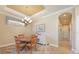 Charming dining area with a tray ceiling and a view of the backyard at 5020 Savona Run, Bradenton, FL 34211