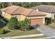 Charming single-Gathering home featuring a well-manicured lawn and a two-car garage at 5020 Savona Run, Bradenton, FL 34211