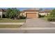 Charming home showcasing manicured landscaping, tile roof and a paver driveway leading to the garage at 5020 Savona Run, Bradenton, FL 34211