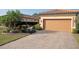 Beautiful house featuring a paver driveway, manicured landscaping and tile roof at 5020 Savona Run, Bradenton, FL 34211