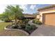 Landscaped front yard with lush plantings, paved walkway and swaying palm trees at 5020 Savona Run, Bradenton, FL 34211