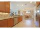 Kitchen featuring granite countertops, stainless steel appliances, and tiled floors open to dining area at 5020 Savona Run, Bradenton, FL 34211