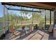 Screened-in lanai with outdoor dining set and lush landscaping at 5020 Savona Run, Bradenton, FL 34211