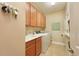 Bright laundry room featuring cabinets, a utility sink and a modern washer and dryer at 5020 Savona Run, Bradenton, FL 34211