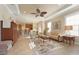 Open-concept living room featuring a tray ceiling, ceiling fan, and neutral decor at 5020 Savona Run, Bradenton, FL 34211