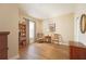 Cozy living room with hardwood floors, built-in bookcase and natural light from a window at 5020 Savona Run, Bradenton, FL 34211