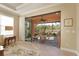 Living room with tile flooring and a large sliding door that opens to a screened lanai at 5020 Savona Run, Bradenton, FL 34211