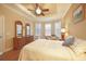 Comfortable main bedroom featuring a tray ceiling, a ceiling fan, and multiple windows at 5020 Savona Run, Bradenton, FL 34211