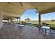 Covered outdoor seating area with views of the lush green golf course and water feature at 5020 Savona Run, Bradenton, FL 34211