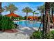 Beautiful pool with comfortable lounge chairs and shaded cabanas amidst lush foliage at 5020 Savona Run, Bradenton, FL 34211