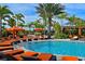 Stunning pool area with lounge chairs, cabanas and tropical landscaping for relaxation at 5020 Savona Run, Bradenton, FL 34211