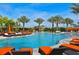 Resort-style pool area featuring lounge chairs, palm trees, and inviting blue water at 5020 Savona Run, Bradenton, FL 34211