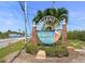 Welcome to Dunedin Causeway sign with palm trees and lush landscaping at 625 Duchess Blvd, Dunedin, FL 34698