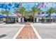 Street-level view of building entrance with palm trees lining the walkway on a sunny day at 111 S Pineapple Ave # 915, Sarasota, FL 34236