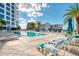 Luxury outdoor pool with stylish lounge chairs, palm trees, and sunny blue skies above modern condos at 111 S Pineapple Ave # 915, Sarasota, FL 34236