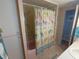 Cozy bathroom featuring a shower/tub with a beach-themed curtain and a small storage cabinet at 1750 Palm Springs St, Sarasota, FL 34234