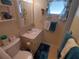 Well-lit bathroom featuring a white vanity, mirror, and a toilet with coordinated decor accents at 1750 Palm Springs St, Sarasota, FL 34234