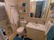 Bathroom featuring a shower, single vanity, toilet, and shelves for linens at 1750 Palm Springs St, Sarasota, FL 34234