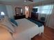 Bedroom with hardwood floors, a ceiling fan, and view to ensuite bathroom at 1750 Palm Springs St, Sarasota, FL 34234
