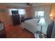 Cozy bedroom featuring hardwood floors and a dresser with a television at 1750 Palm Springs St, Sarasota, FL 34234
