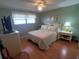 Cozy bedroom featuring hardwood floors, a ceiling fan, and a comfortable bed at 1750 Palm Springs St, Sarasota, FL 34234
