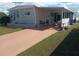 The property has a covered patio, a pristine lawn, and a comfortable outdoor seating area at 1750 Palm Springs St, Sarasota, FL 34234