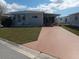 Charming single-story home with a cozy covered patio and well-maintained lawn at 1750 Palm Springs St, Sarasota, FL 34234