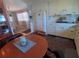 Kitchen featuring white cabinets, stone-look floors, and an adjacent dining area at 1750 Palm Springs St, Sarasota, FL 34234