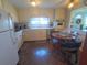 Well-lit kitchen with white cabinetry, stone-look flooring, and a cozy breakfast nook at 1750 Palm Springs St, Sarasota, FL 34234