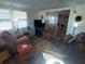 Well-lit living room with sliding door and a glimpse into the adjacent living space at 1750 Palm Springs St, Sarasota, FL 34234