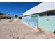 Exterior view of recreation area featuring a tiki hut, pool, and recreation building with mural at 1750 Palm Springs St, Sarasota, FL 34234