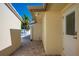 The exterior side of this home features stone pavers, secure backyard entry, and the building's neutral color scheme at 231 Hourglass Way # V5, Sarasota, FL 34242