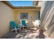 Welcoming outdoor patio featuring comfortable chairs, a view of lush landscaping and a tranquil atmosphere at 231 Hourglass Way # V5, Sarasota, FL 34242