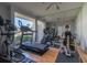 This light-filled gym includes a treadmill and an elliptical machine with floor-to-ceiling mirrors and natural light at 231 Hourglass Way # V5, Sarasota, FL 34242