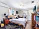 Bedroom with hardwood floors, ceiling fan, and natural light at 2376 Novus St, Sarasota, FL 34237