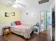Comfortable bedroom with wood floors, a bed, and a view to the kitchen at 2376 Novus St, Sarasota, FL 34237